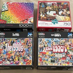 Four jigsaw puzzles— 3 / 1000 piece and one 750 piece.  No missing pieces